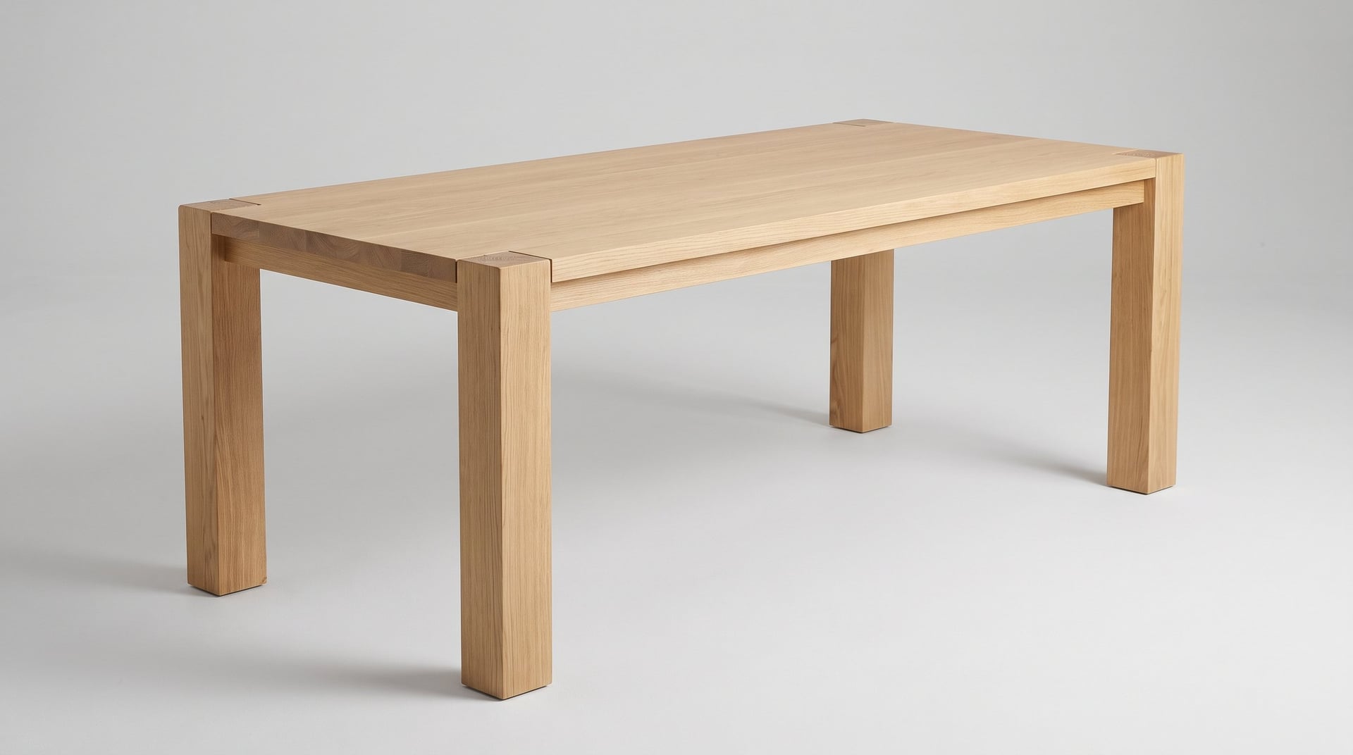 Balkan Dining Table in European oak, studio three-quarter, the posts running through the top