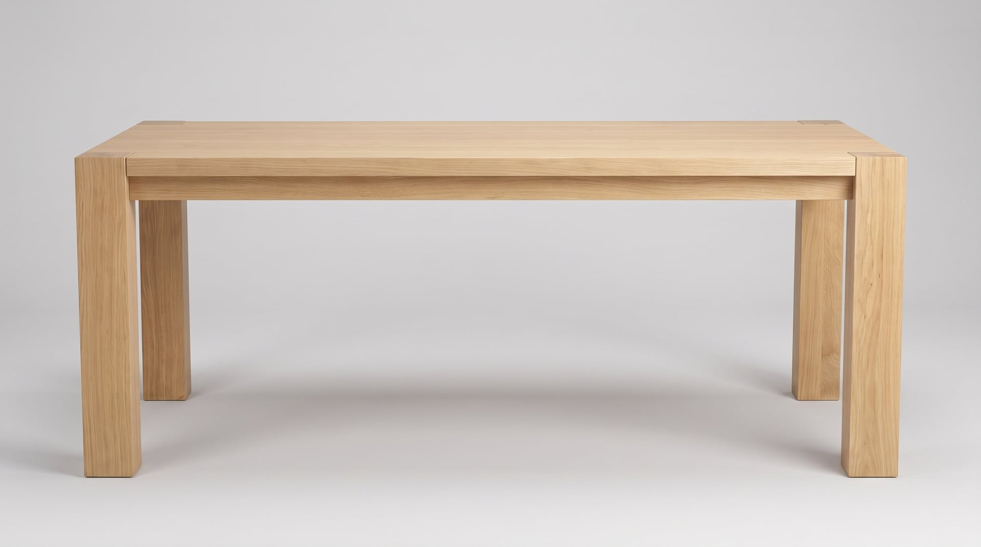 Balkan Dining Table in European oak, studio side view, the band stepped under the top