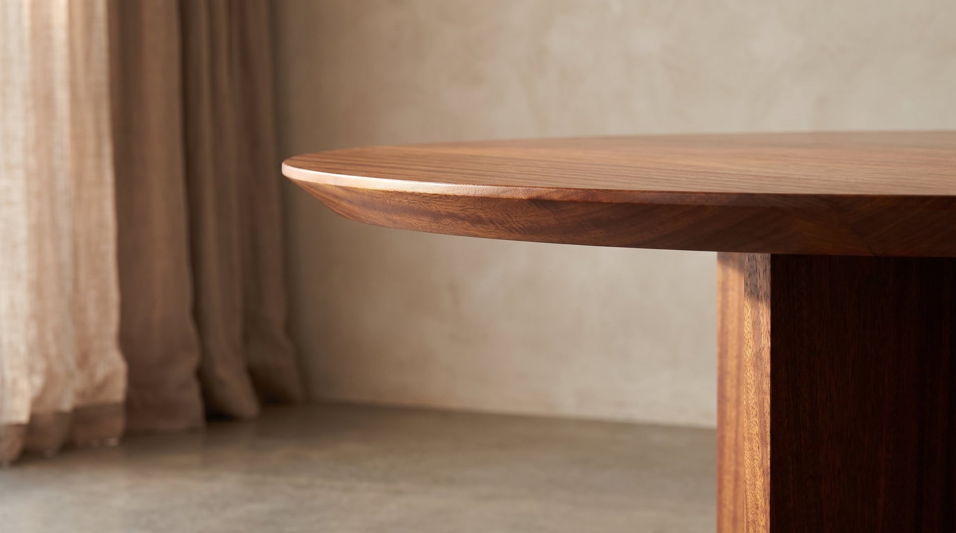 Kouper Round Dining Table in sapele mahogany, the beveled rim and a blade, close