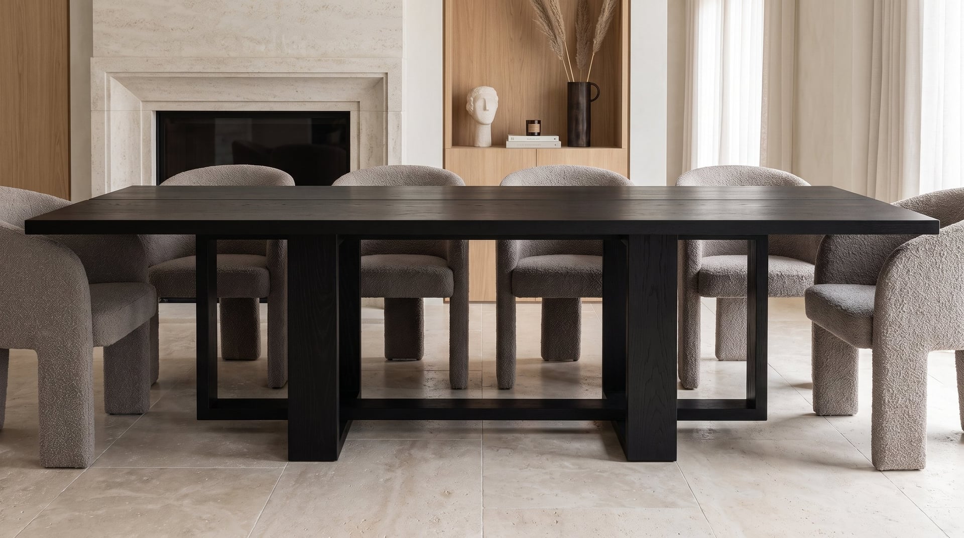 Tesseract Dining Table in black oak, head-on at seated height before a limestone fireplace, the cage and the posts