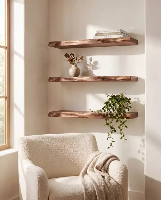 Walnut live edge floating shelves — a sunlit reading corner