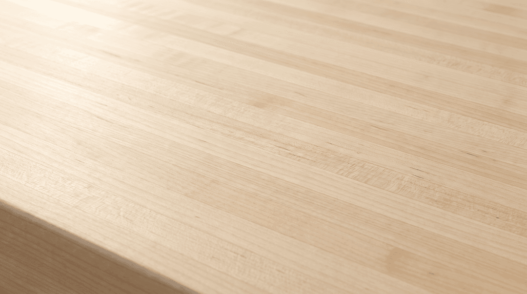 Natural hard maple edge grain butcher block countertop close-up, pale laminated strips under a clear hardwax oil