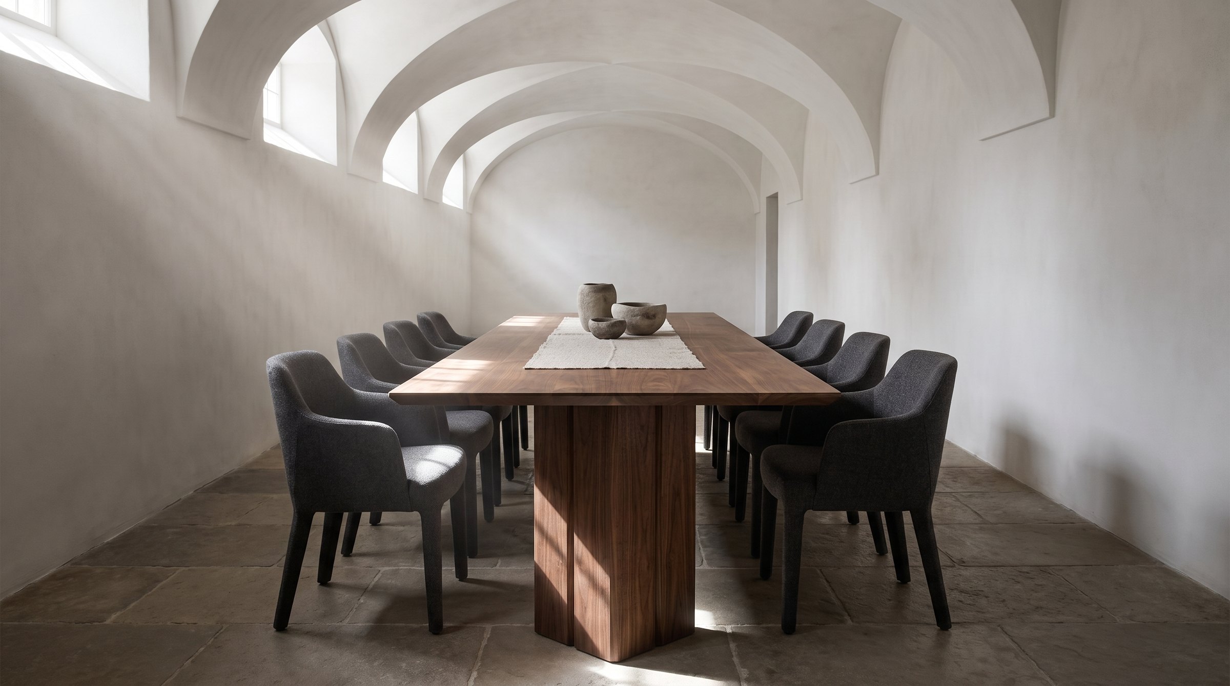 Solid walnut dining table, face grain — the Vekt Walnut Dining Table in a vaulted refectory with clerestory windows, the 114-inch seating ten