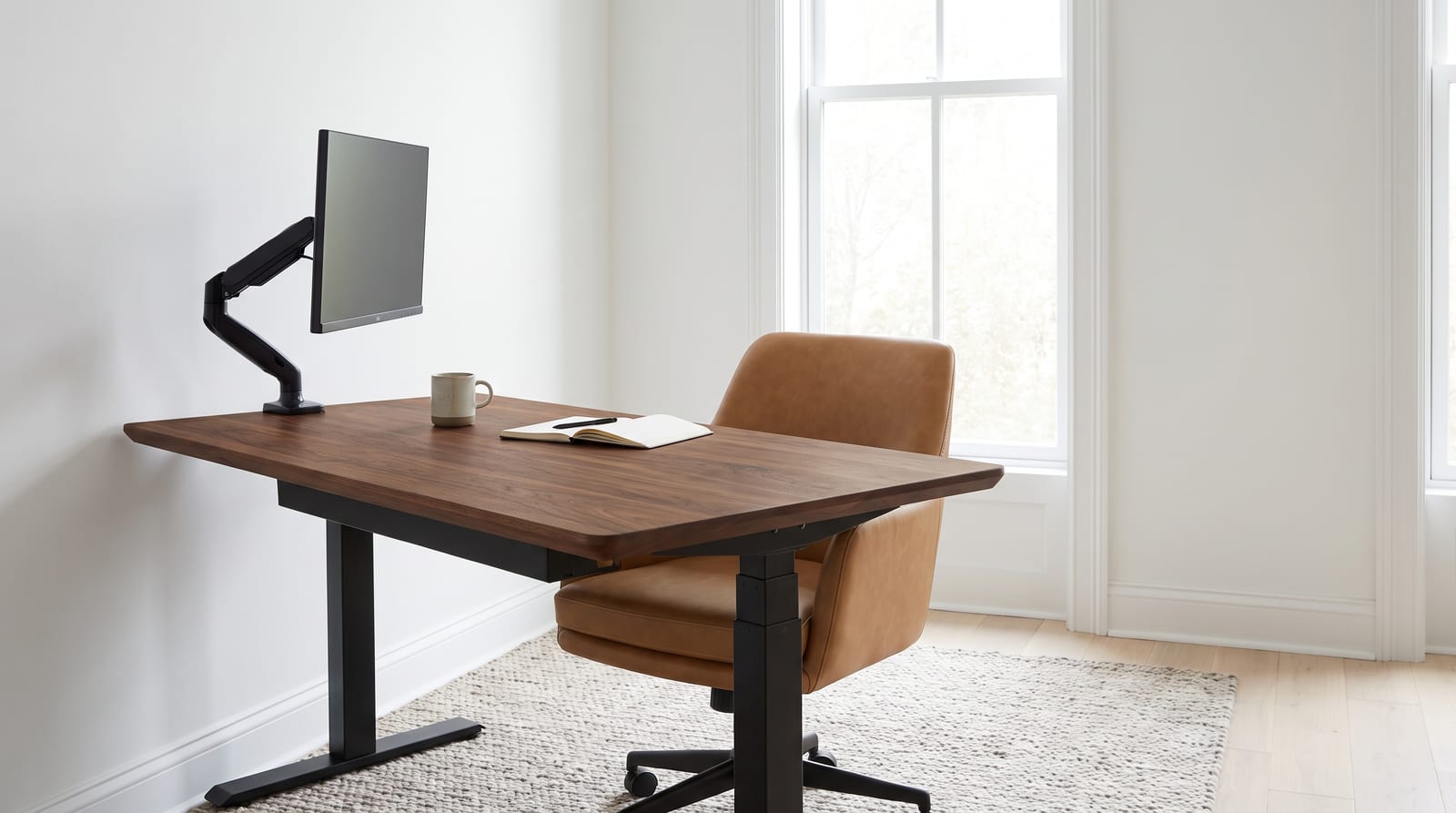 Solid walnut tabletop, face grain — a bright home office, walnut desk top on a sit-stand frame