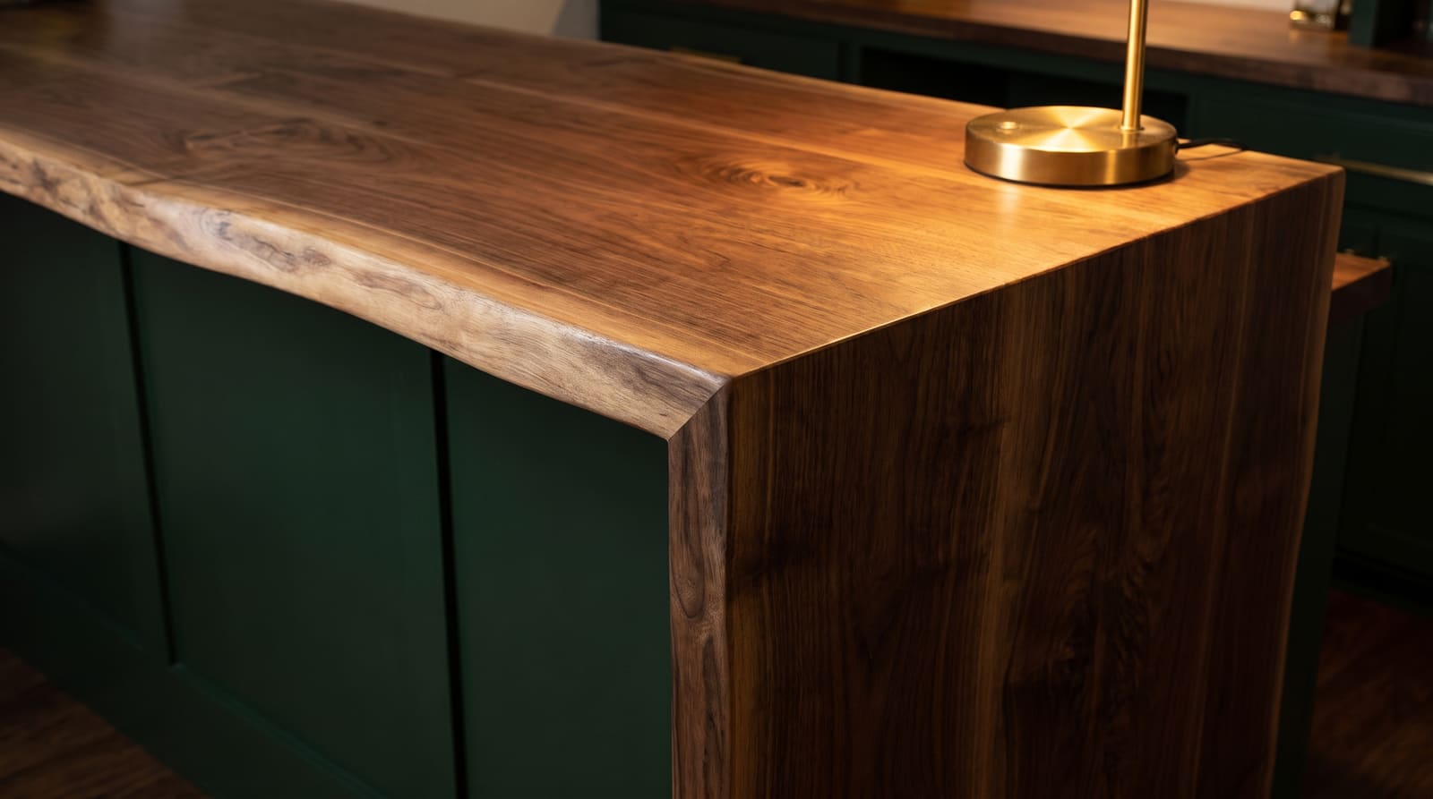 Solid walnut countertop, live edge — a home bar, live-edge walnut bar top turning down at a waterfall corner