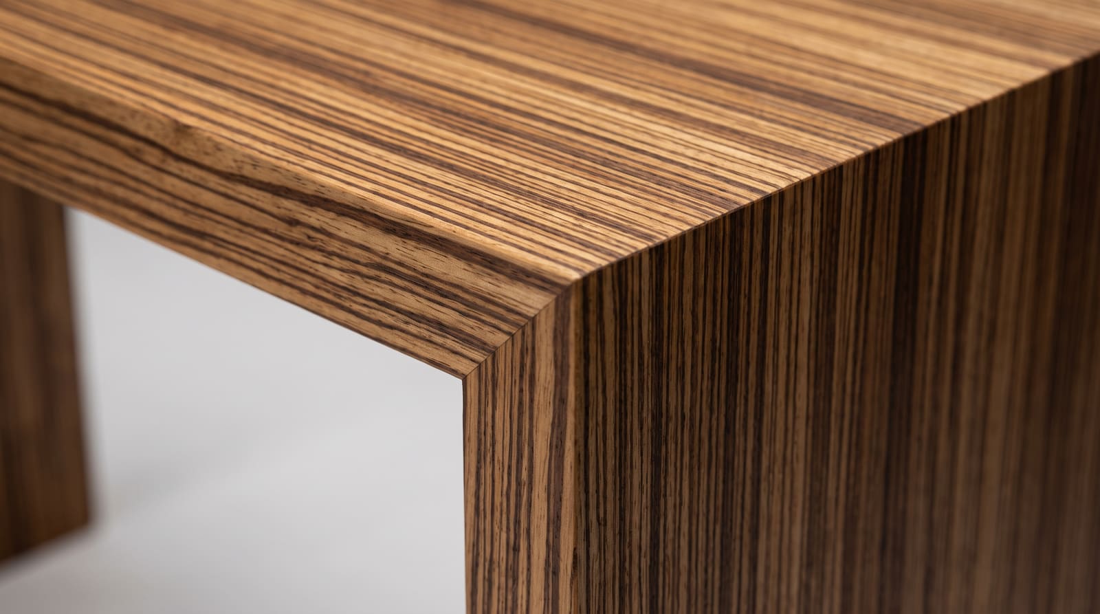 Solid zebrawood tabletop, face grain — close-up of a zebrawood waterfall corner